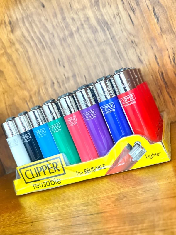 Clipper reusable lighter in a variety of colours on wood background