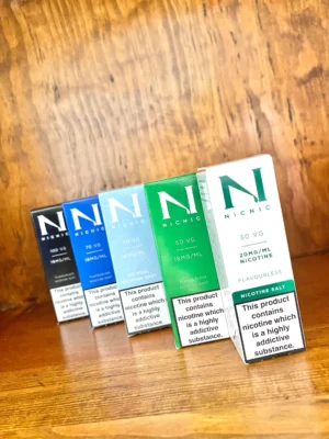 Nic-nic-flourless-nicotine-shot-10ml Nic nic flavourless nicotine shots in a 50VG, 70VG, 100VG, salt nicotine and ice in 10ml bottle on wood background