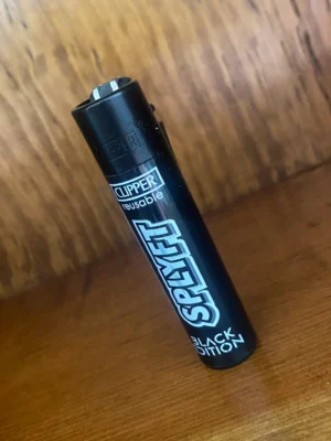 Clipper-splyft-reusable-lighter Clipper splyft reusable lighter in black on wood background