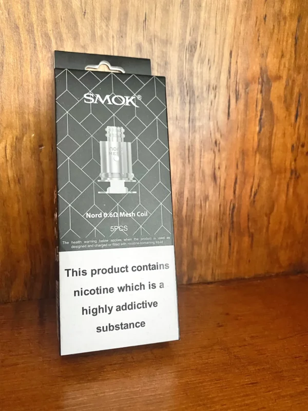 Smok nord 0.6 ohm 5 pack on wood background