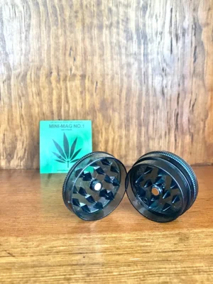 Mini mag black 2 piece grinder on wood background
