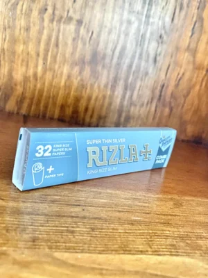 Rizla 32 king size super slim rolling papers with tips on wood background