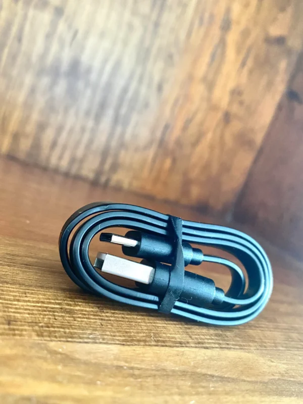 USB-C charging cable on wood background